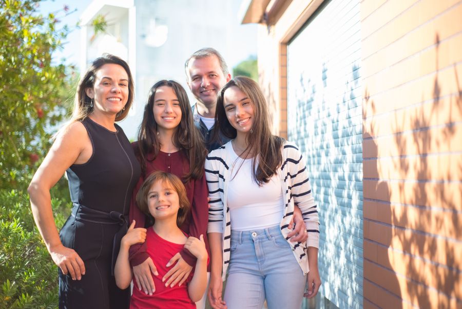 A whole family of five together, smiling